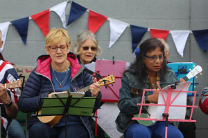 two women reading music and playing the ukelele
