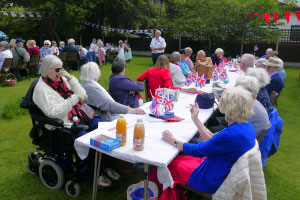 People at an outside table chatting to each other