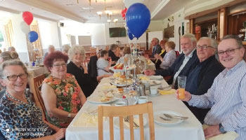 People at a table smiling