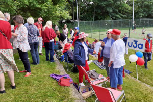 A group of people outside chatting and socialising