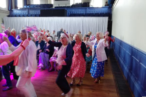 People dancing holding union jack flags