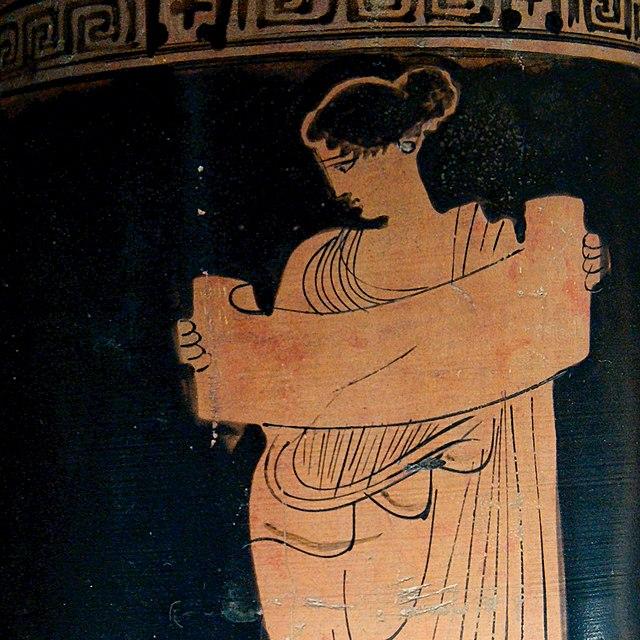 Reading a scroll on a greek vase