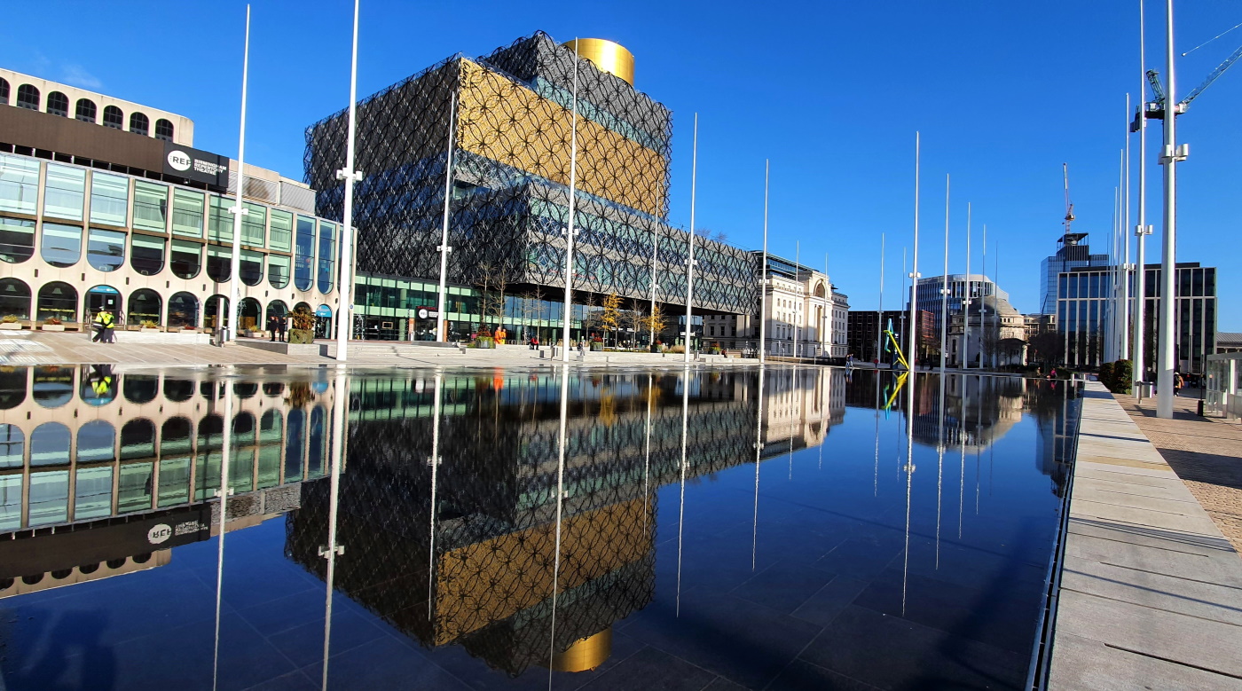 city reflected on smooth water surface