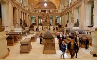 a museum in egpyt with people walking through a large hall 