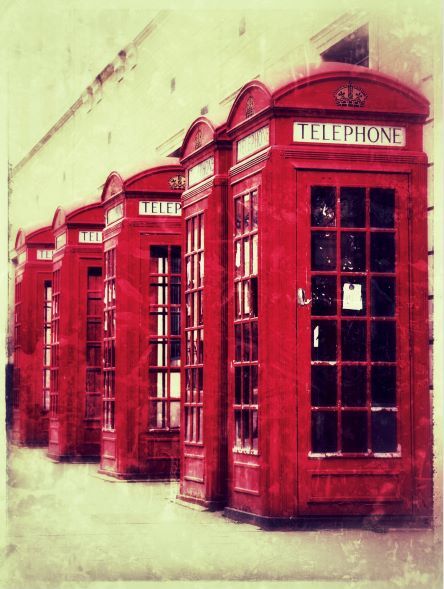 a line of 5 red telephone boxes