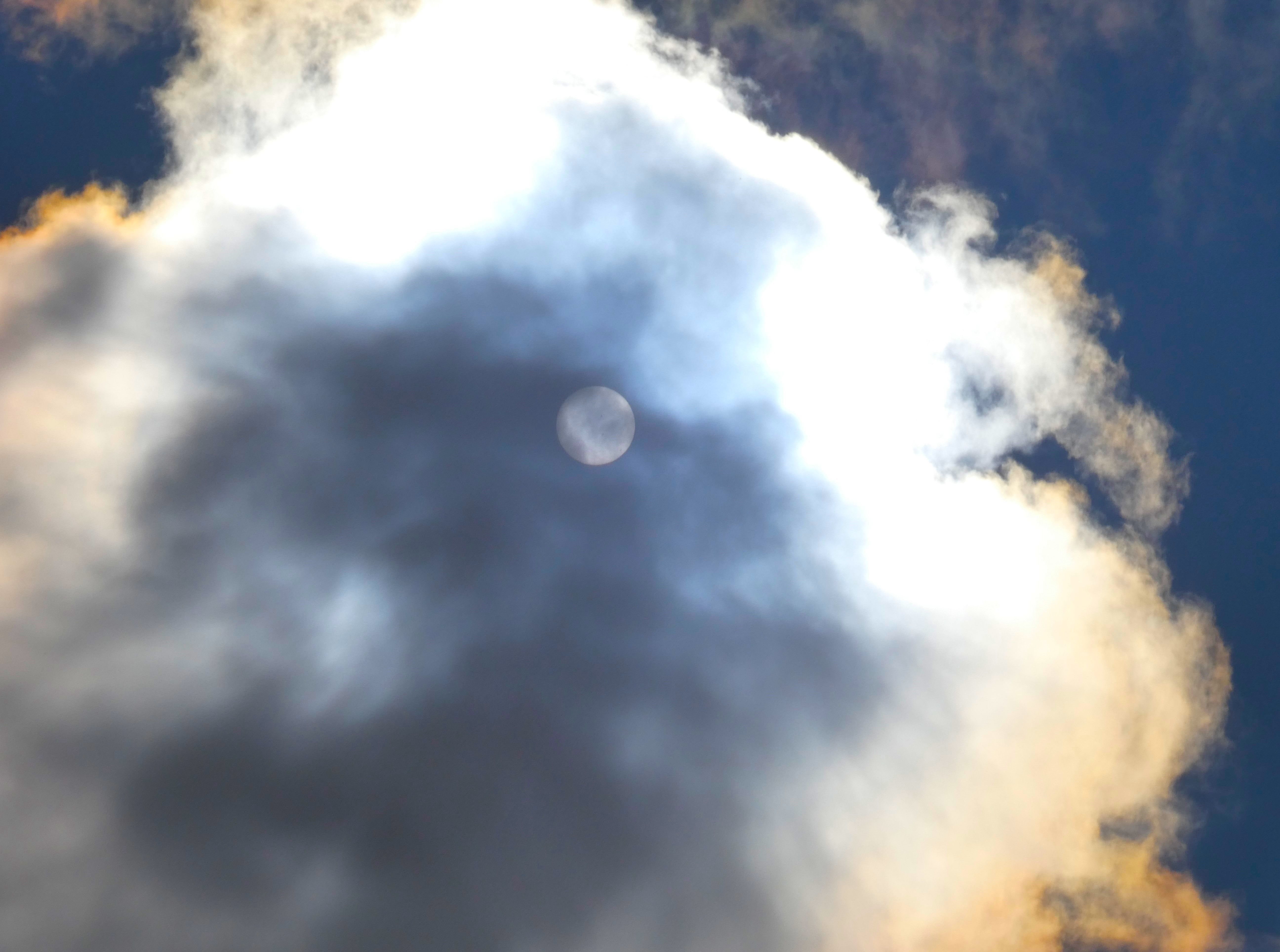 The sun behind a cloud