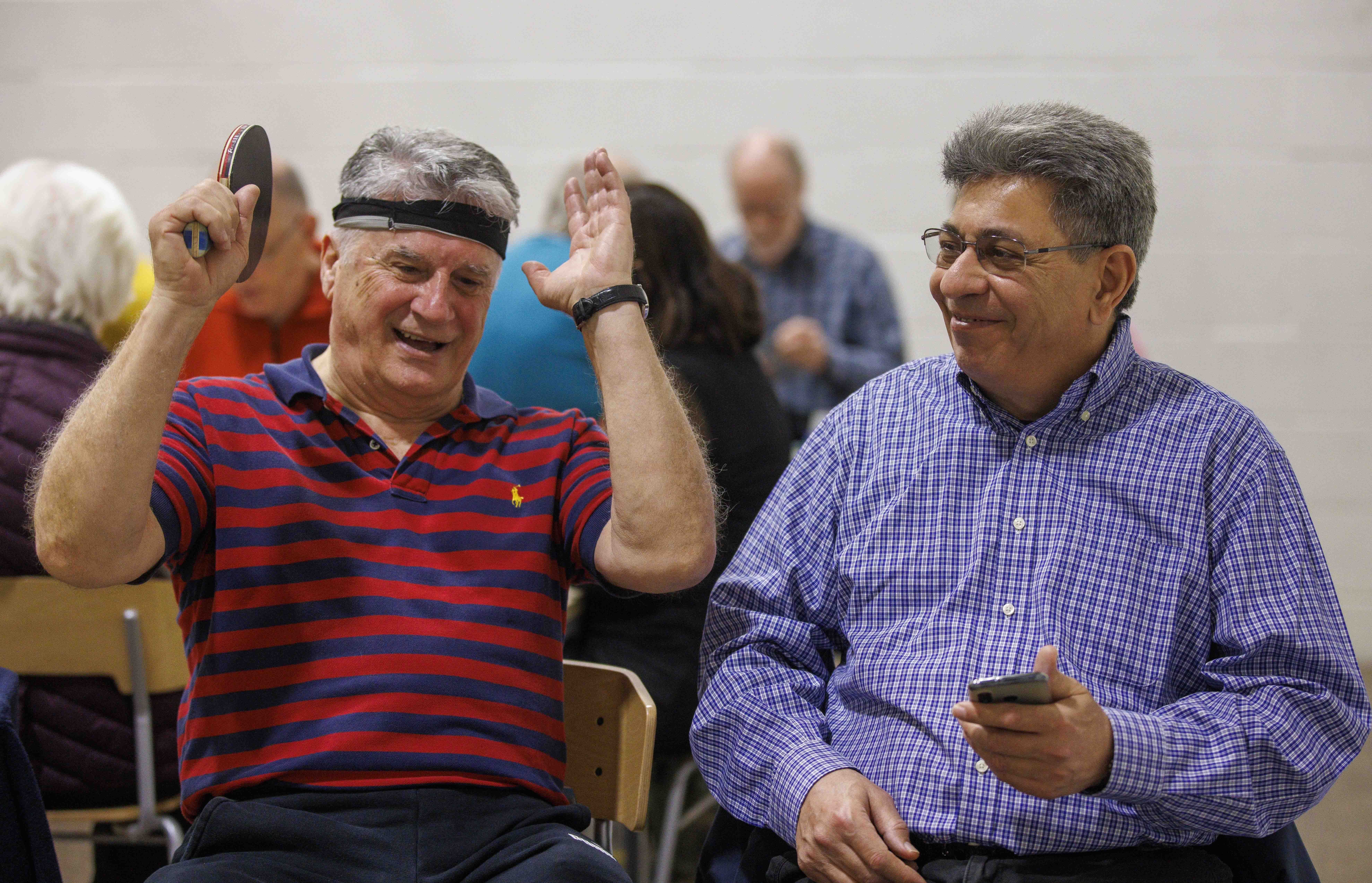 Two members of Slough u3a talking after a game of table tennis