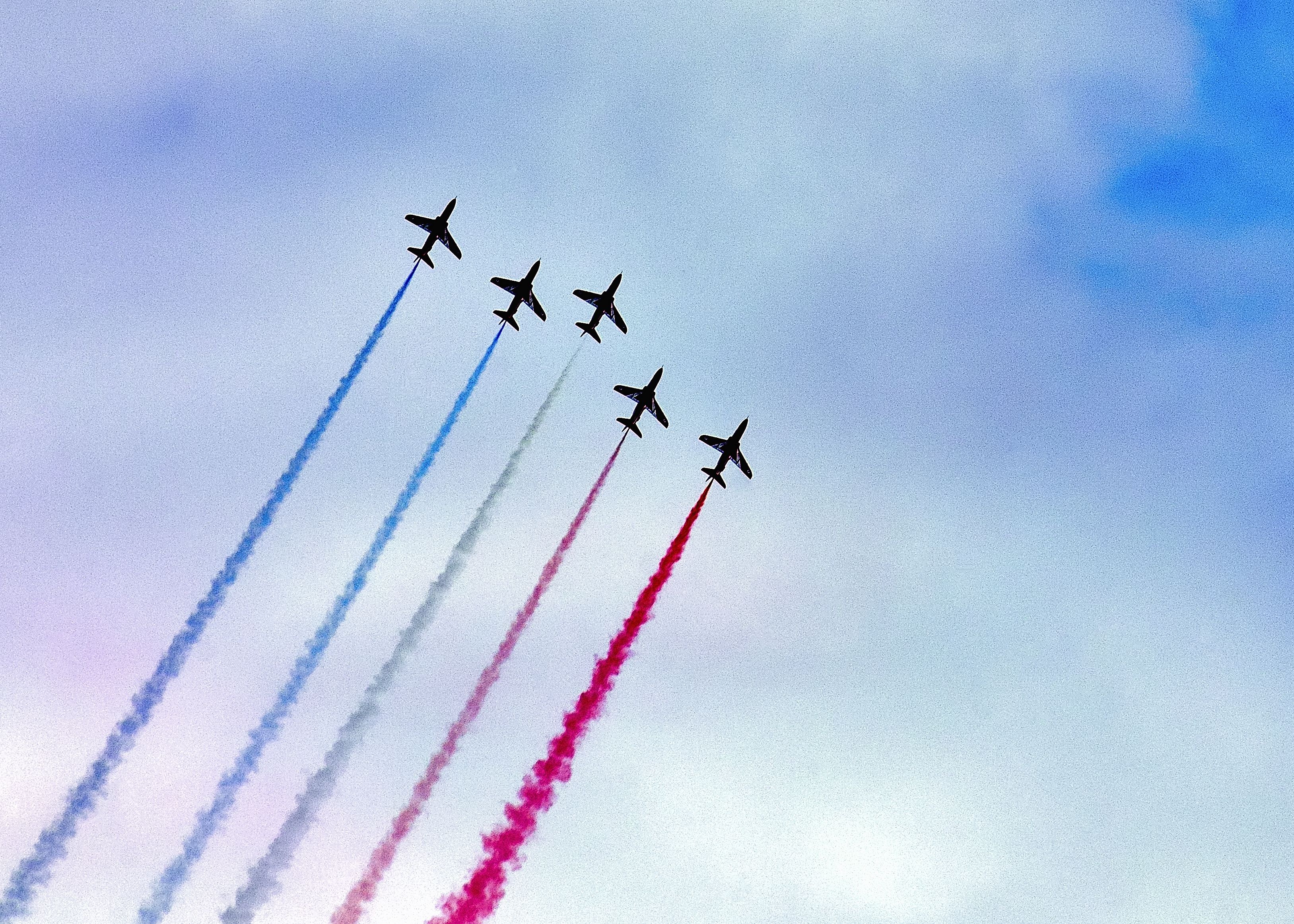 6 planes in the sky with red white and blue trails