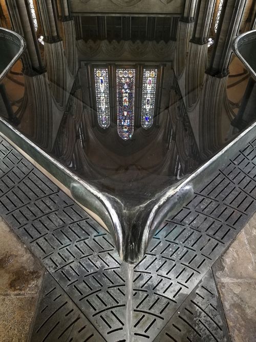 the reflection of a church window in water