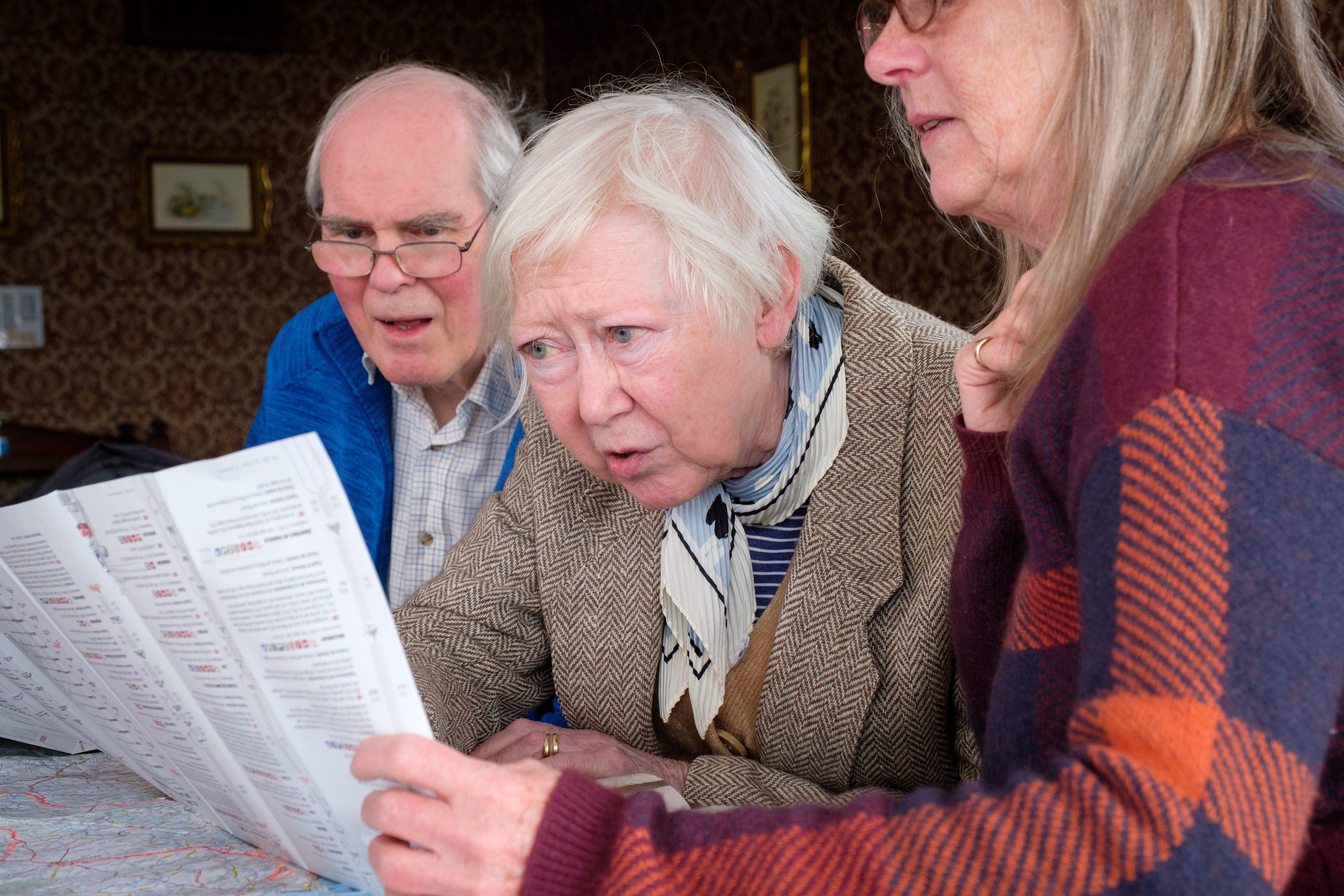 Several u3a members study a map