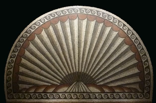 a white an orange semi circle of roman mosaic 