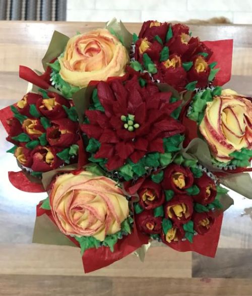 a bouquet of yellow and red flowers piped in icing. birds eye view.